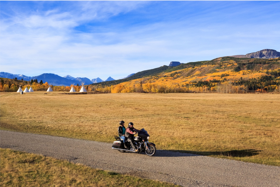 A couple of people on a motorcycle on a road

AI-generated content may be incorrect.